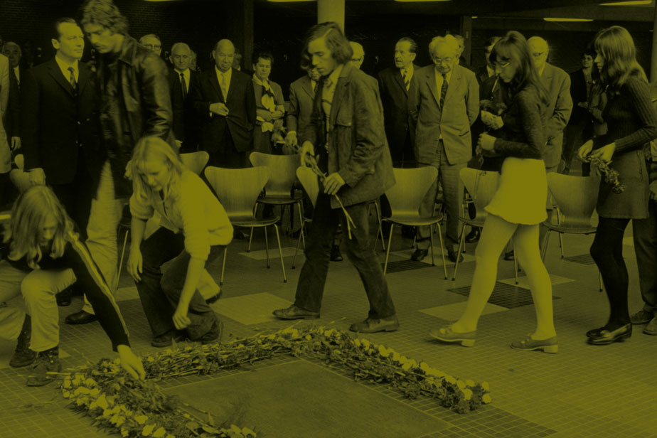 Students frame the memorial plaque for Hamburgs Weiße Rose with red carnations, 1971